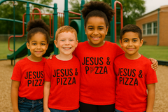 Four children wearing red t-shirts with 'Jesus & Pizza' text on a playground.